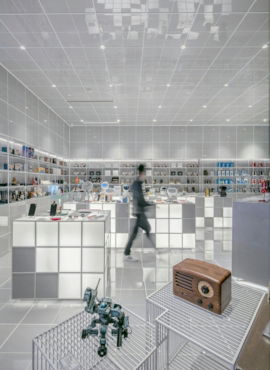 man walking beside white cube decoration