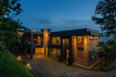 a house with a lot of windows lit up at night