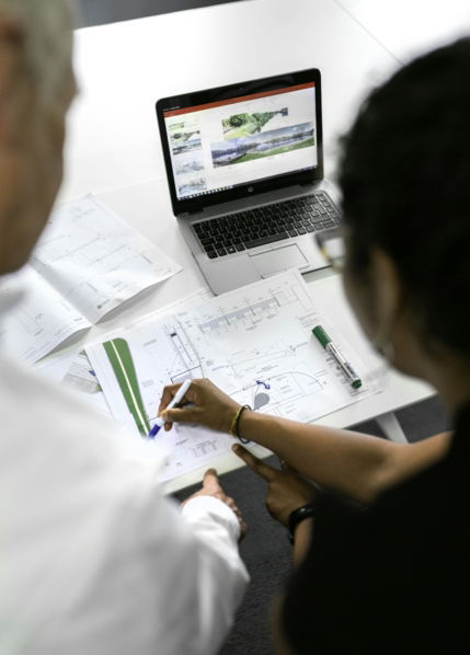 woman in white shirt writing on white paper